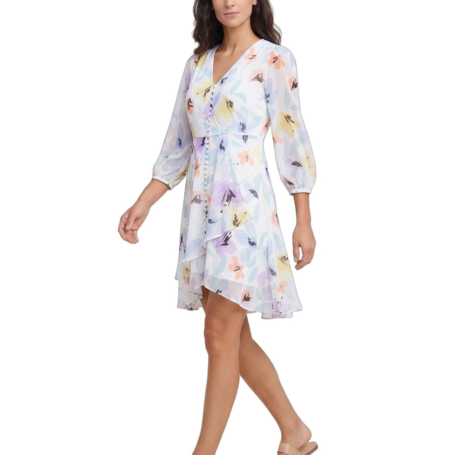 Woman wearing a floral Calvin Klein dress on a white background