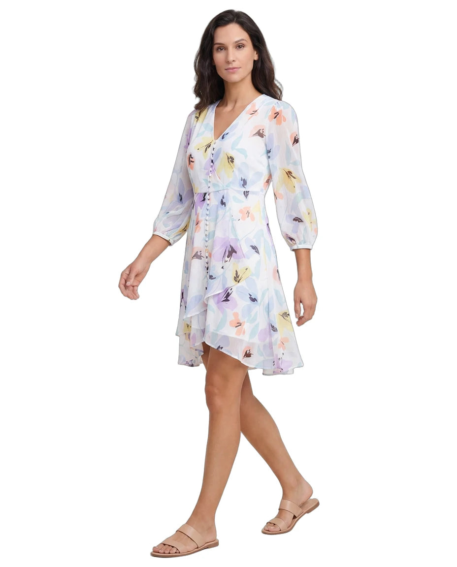 Woman wearing a floral Calvin Klein dress on a white background
