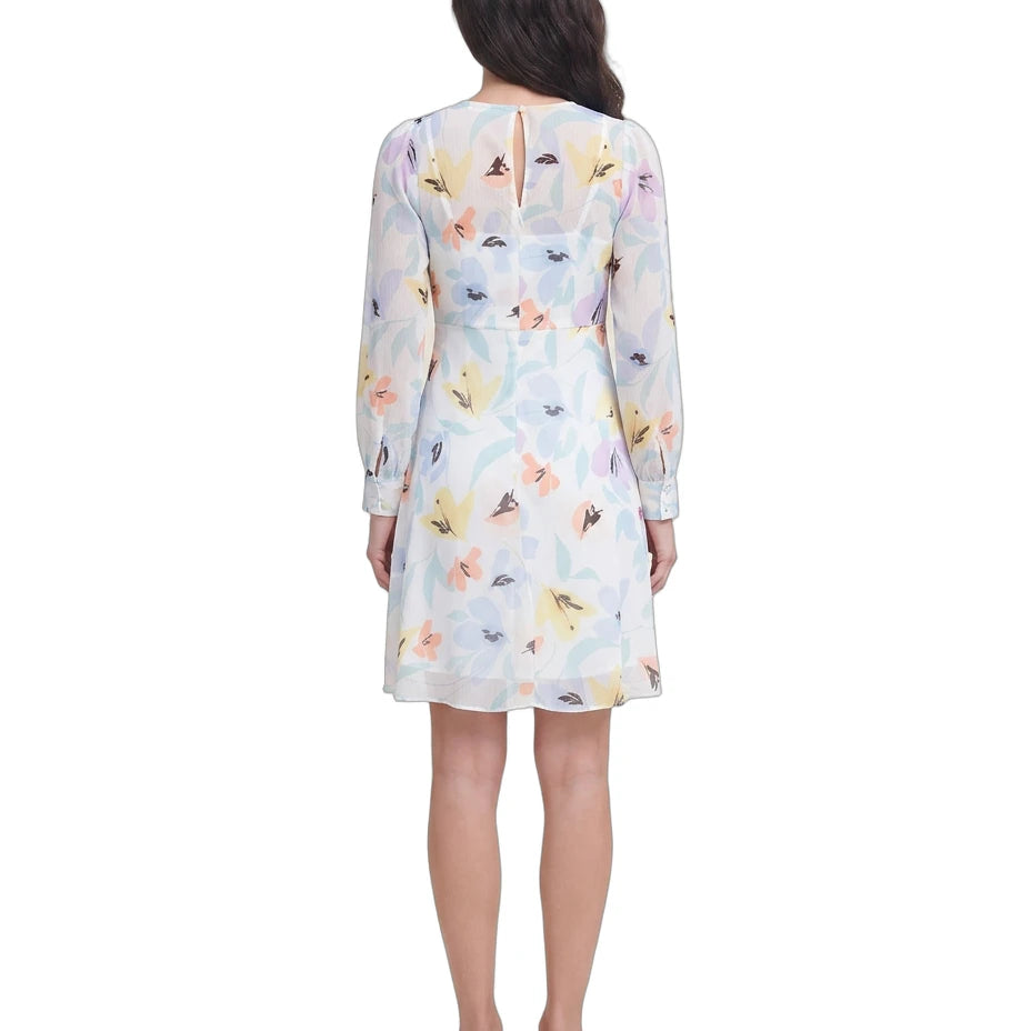 Woman wearing a floral Calvin Klein dress on a white background