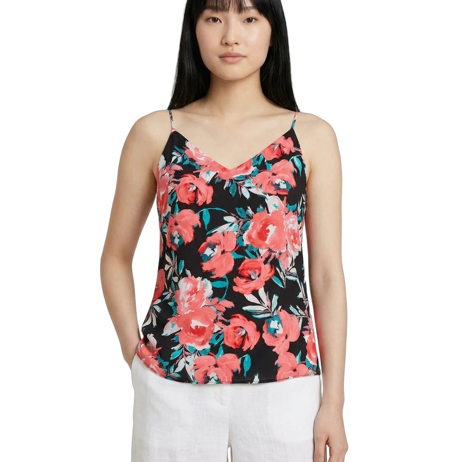 Woman wearing a floral camisole top on a white background