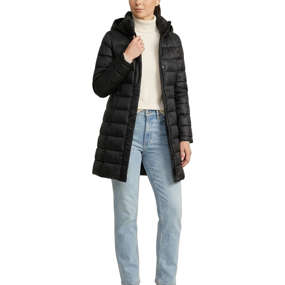Woman wearing a black Calvin Klein puffer coat on a white background