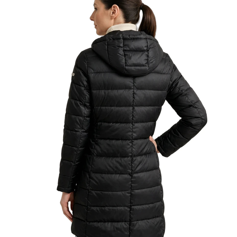 Woman wearing a black Calvin Klein puffer coat on a white background