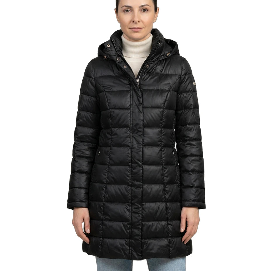 Woman wearing a black Calvin Klein winter coat on a white background