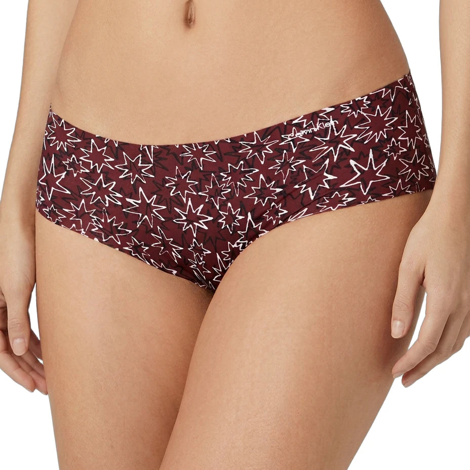 Maroon bikini bottom with star pattern worn by a person on a white background