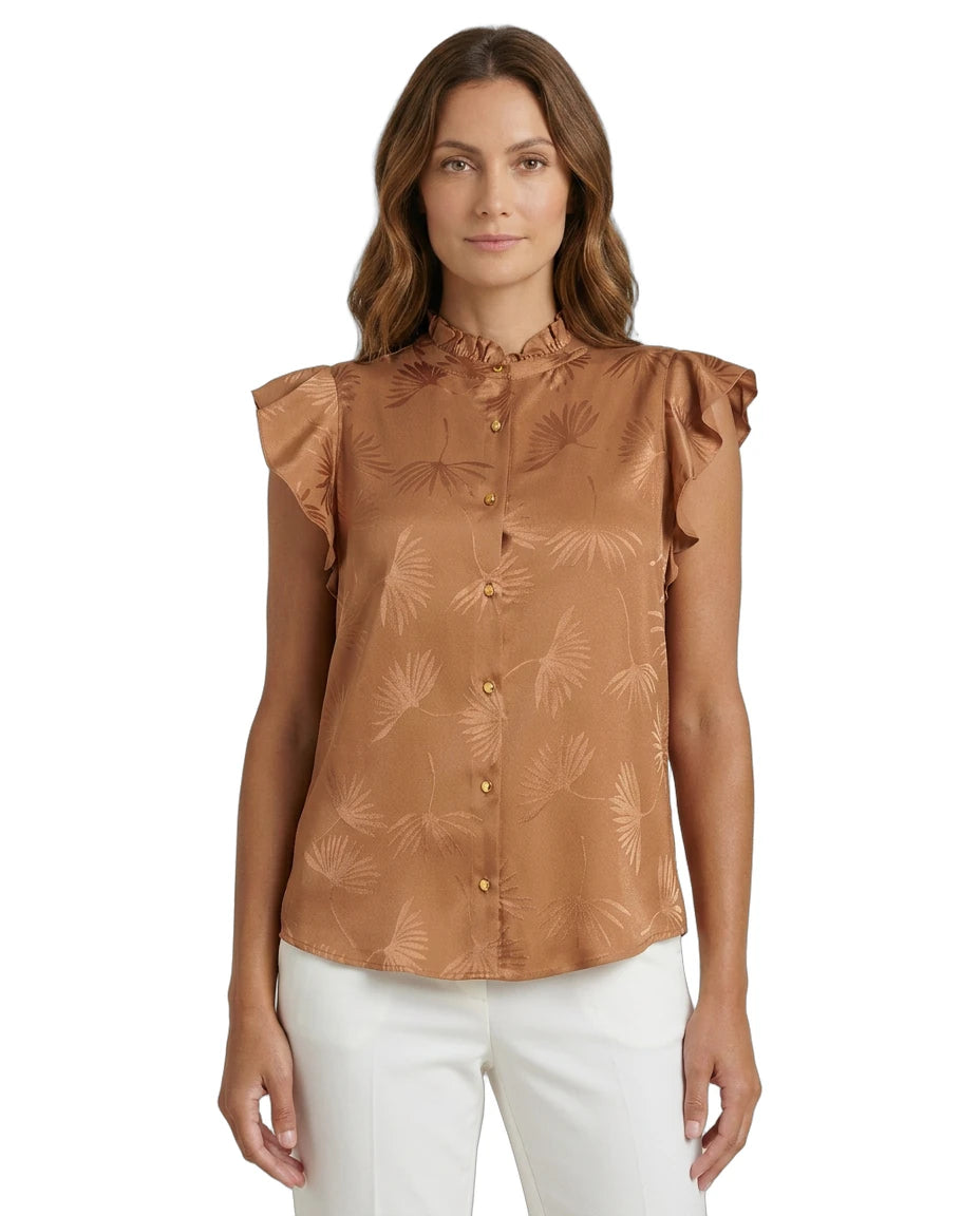 Woman wearing a brown Calvin Klein blouse with floral pattern on a white background