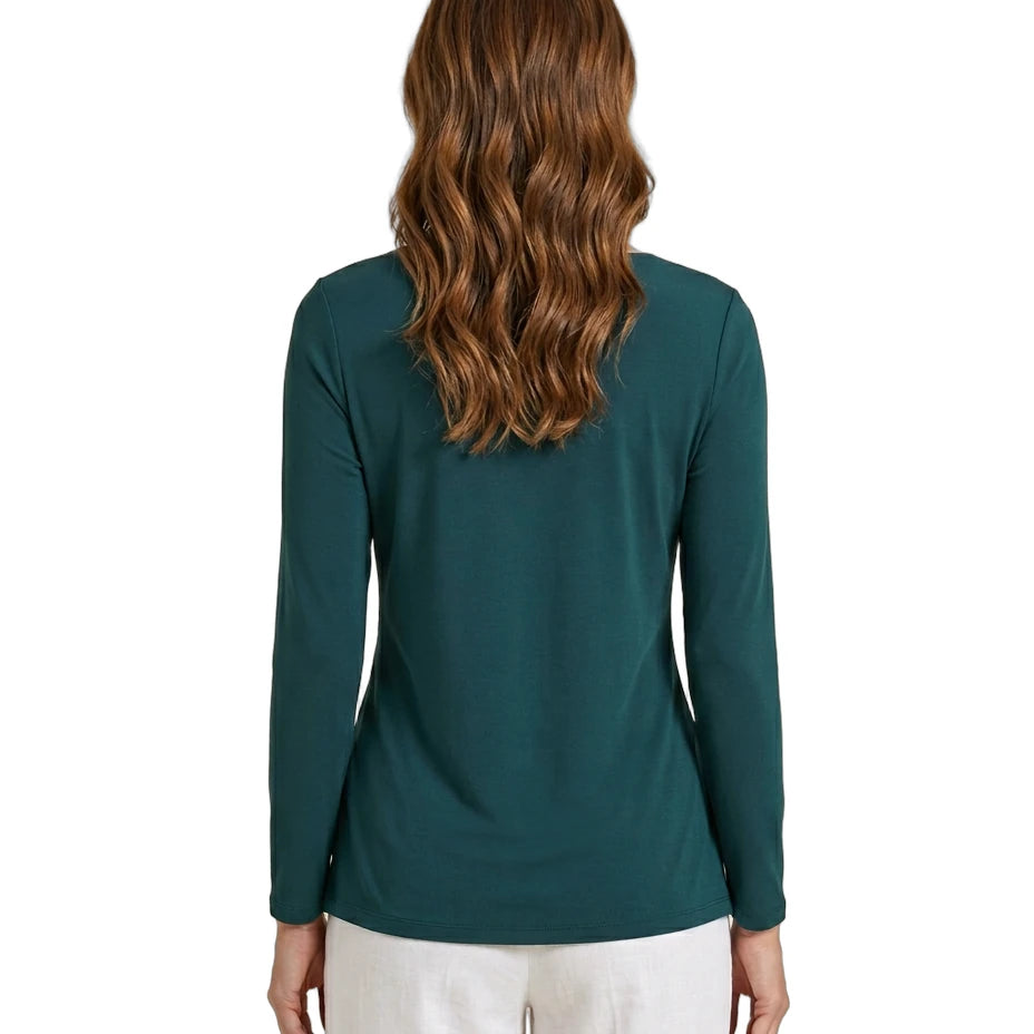 Woman wearing a teal Calvin Klein long-sleeve top on a white background