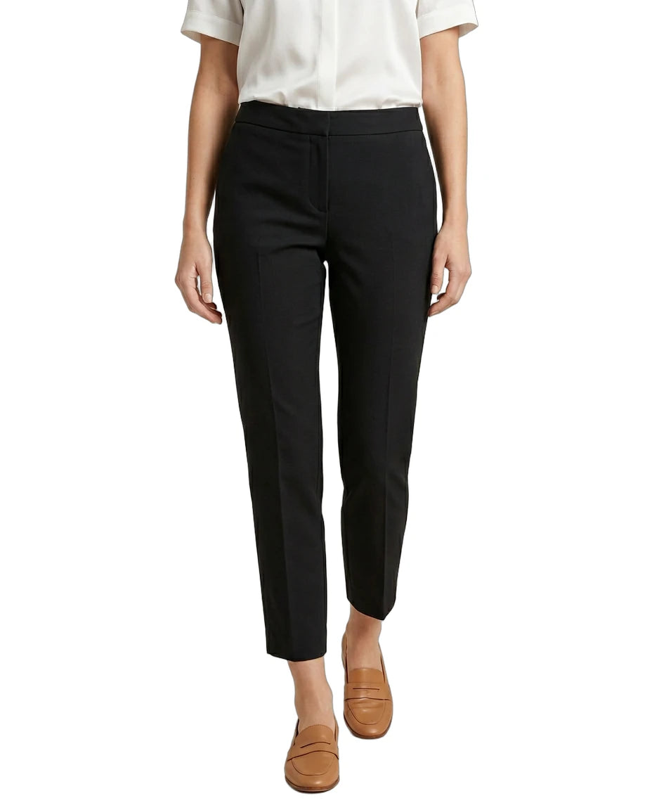 Person wearing black Calvin Klein pants and a white shirt on a white background