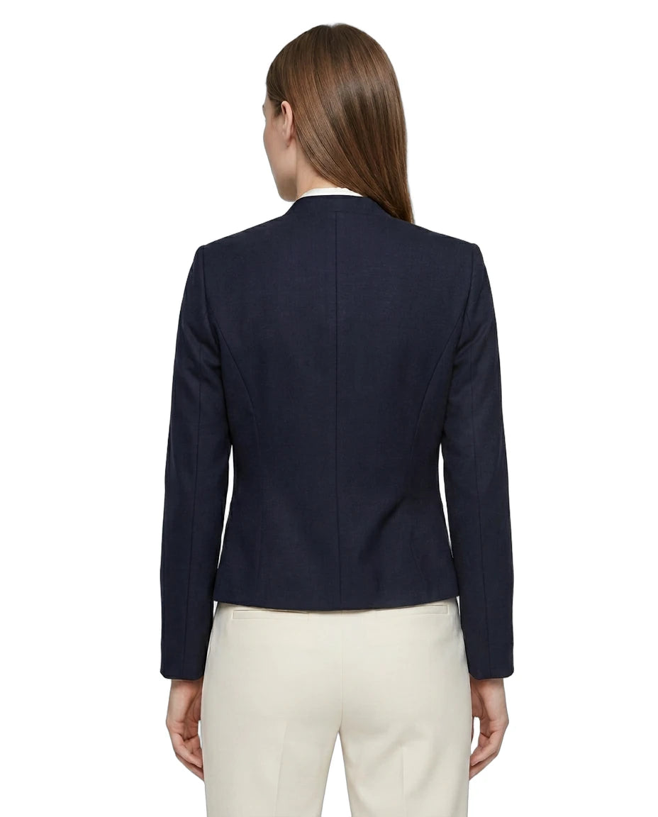 Navy Calvin Klein blazer worn by a person on a white background