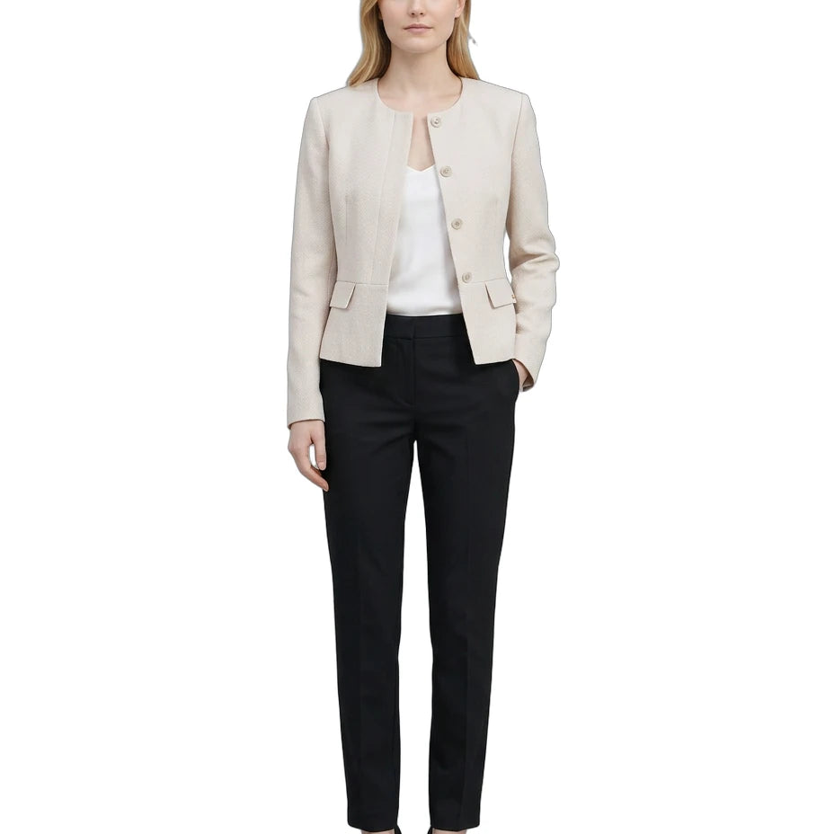 Woman wearing a Calvin Klein beige blazer and black pants on a white background