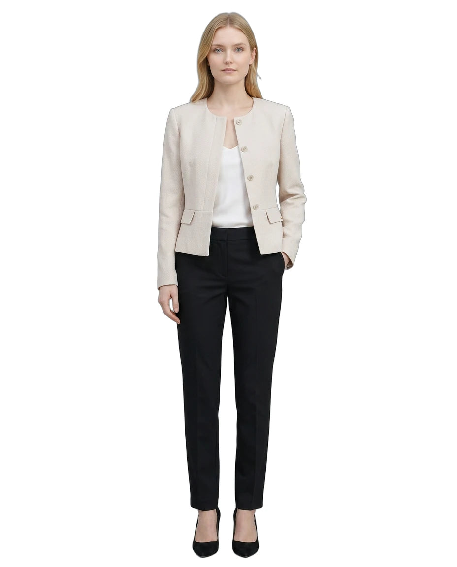 Woman wearing a Calvin Klein beige blazer and black pants on a white background