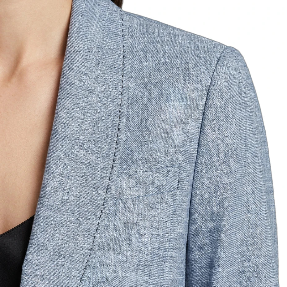 Close-up of a blue Calvin Klein blazer with a pocket on a white background