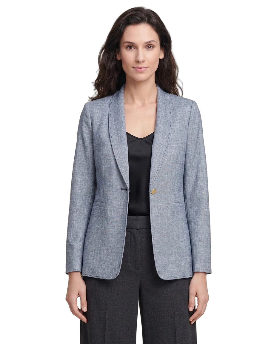 Woman wearing a light blue Calvin Klein checkered blazer over a black top on a white background