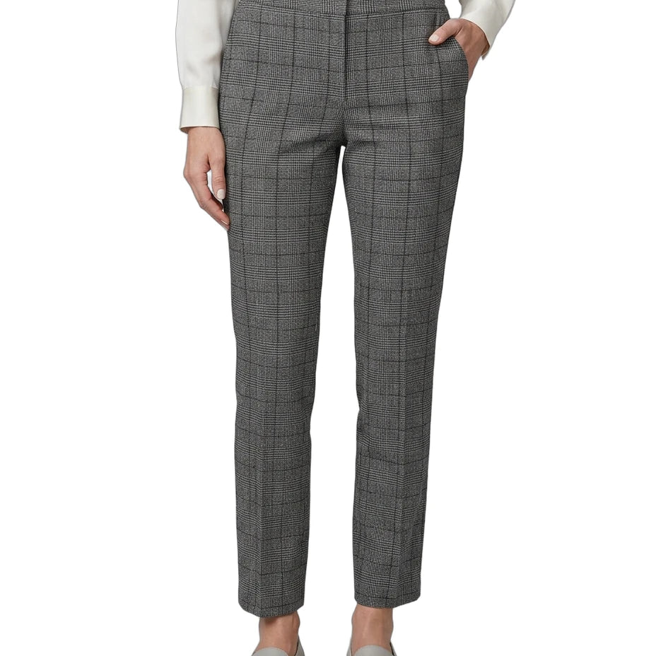 Person wearing gray Calvin Klein checkered pants on a white background