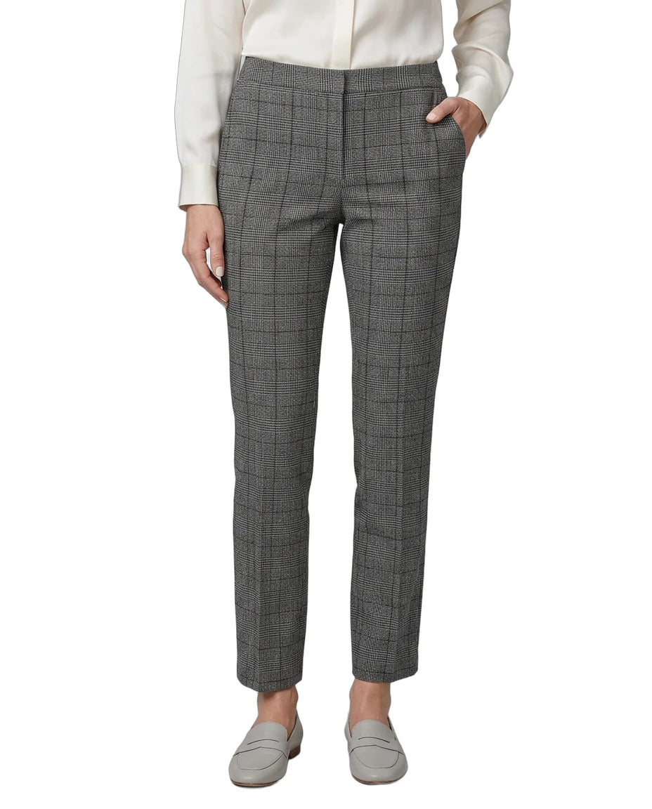 Person wearing gray Calvin Klein checkered pants on a white background