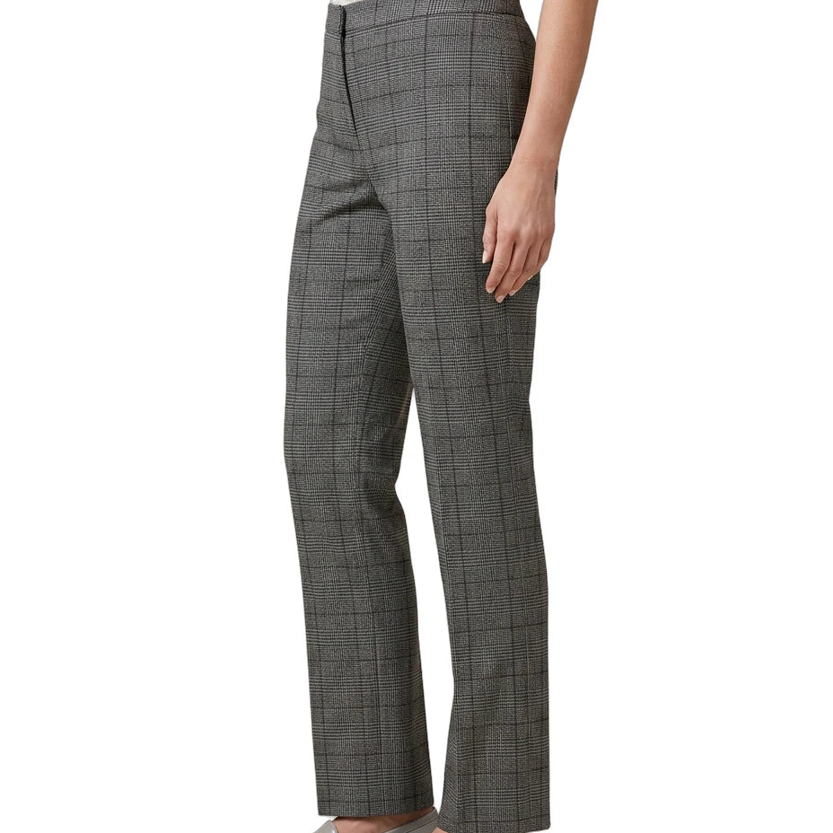 Person wearing gray Calvin Klein checkered pants on a white background