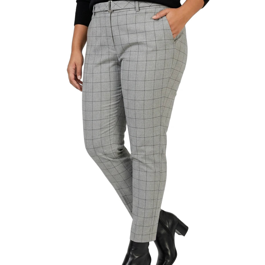 Person wearing Calvin Klein gray checkered pants and black boots on a white background