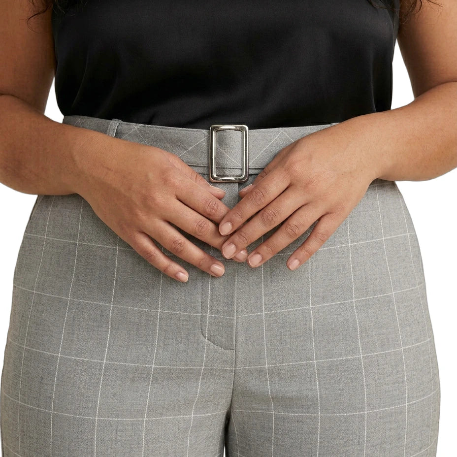Person wearing Calvin Klein gray checkered pants with a black top on a white background
