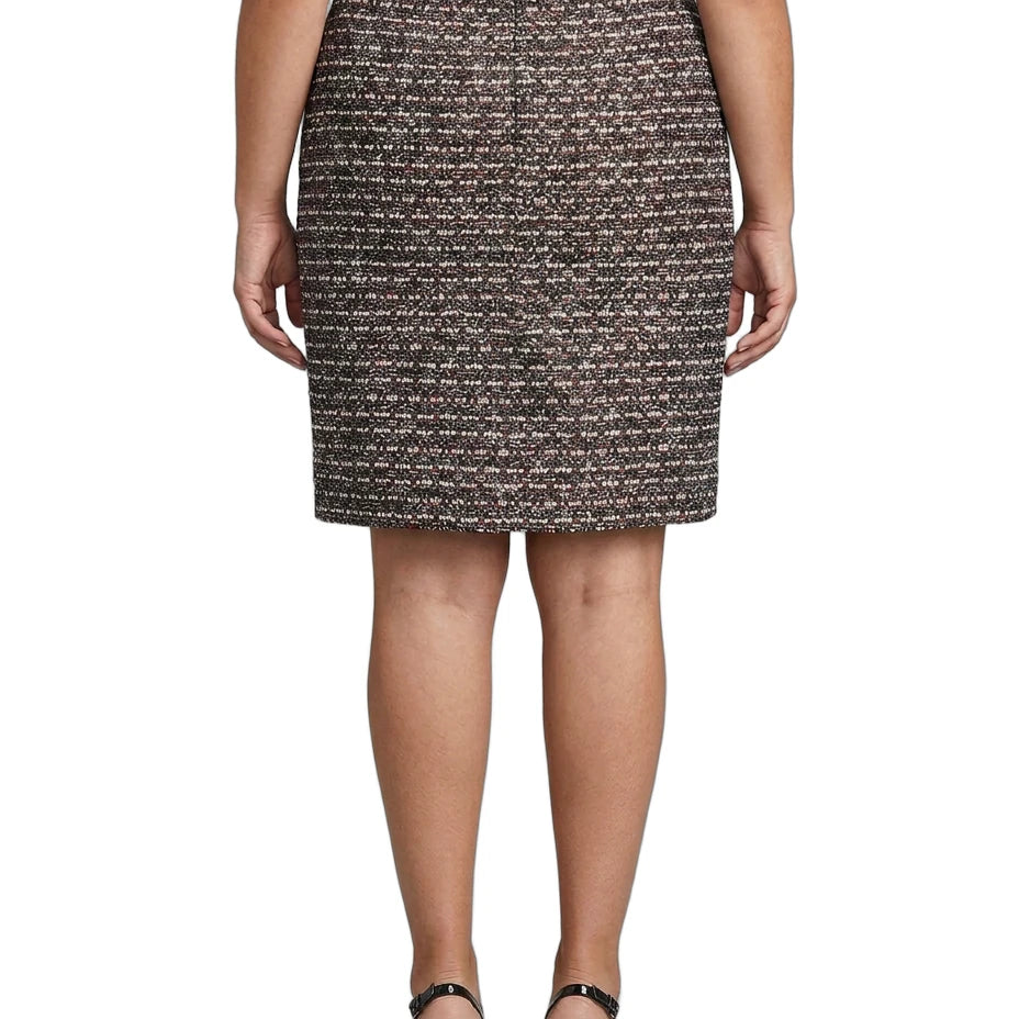 Person wearing a Calvin Klein patterned skirt on a white background
