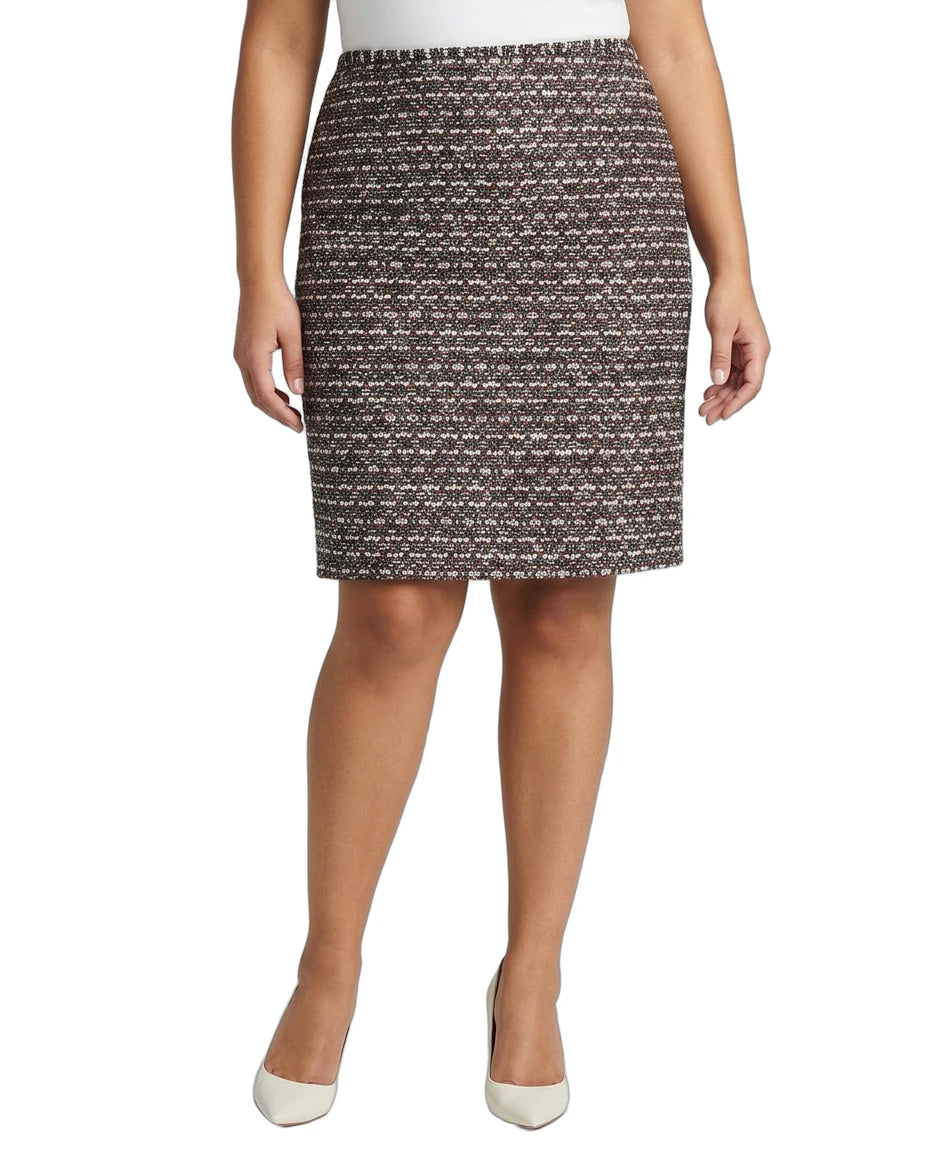 Person wearing a Calvin Klein patterned skirt on a white background