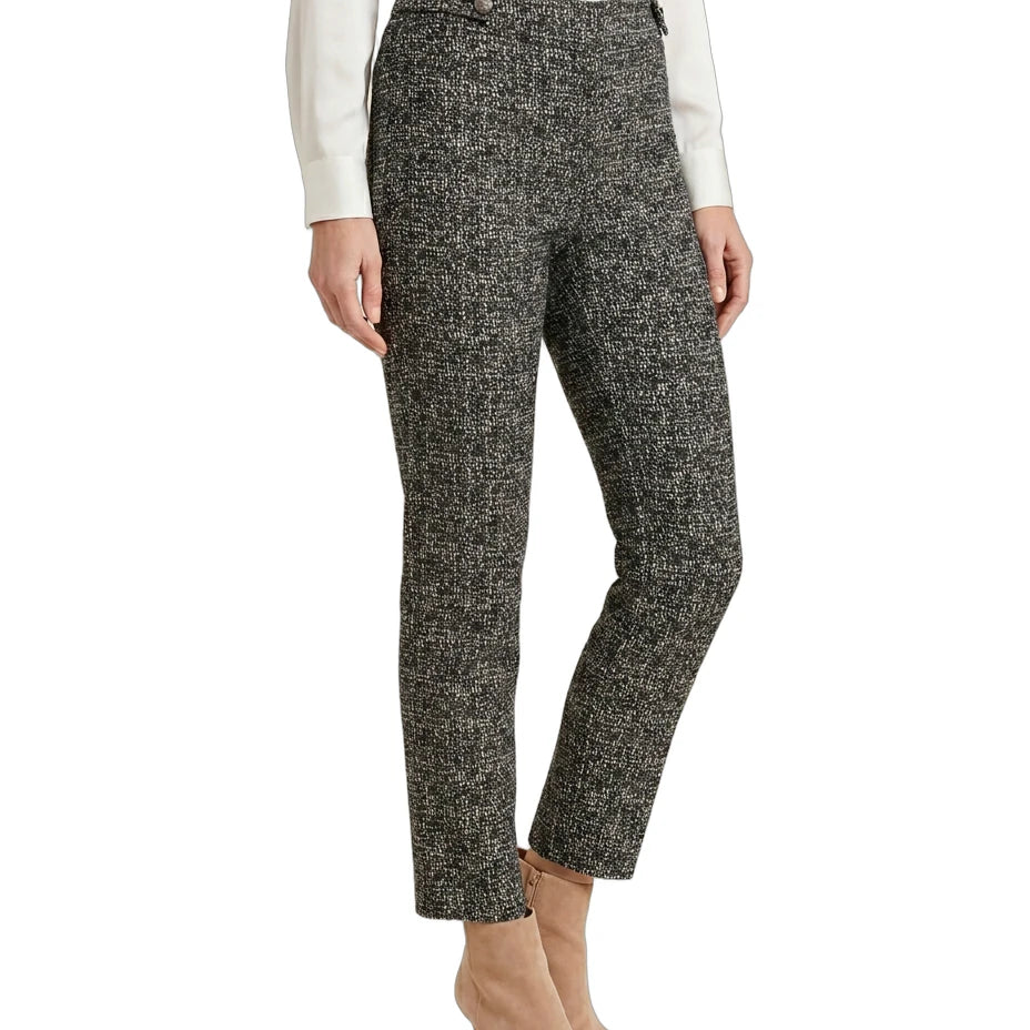 Person wearing black and white patterned Calin Klein pants on a white background