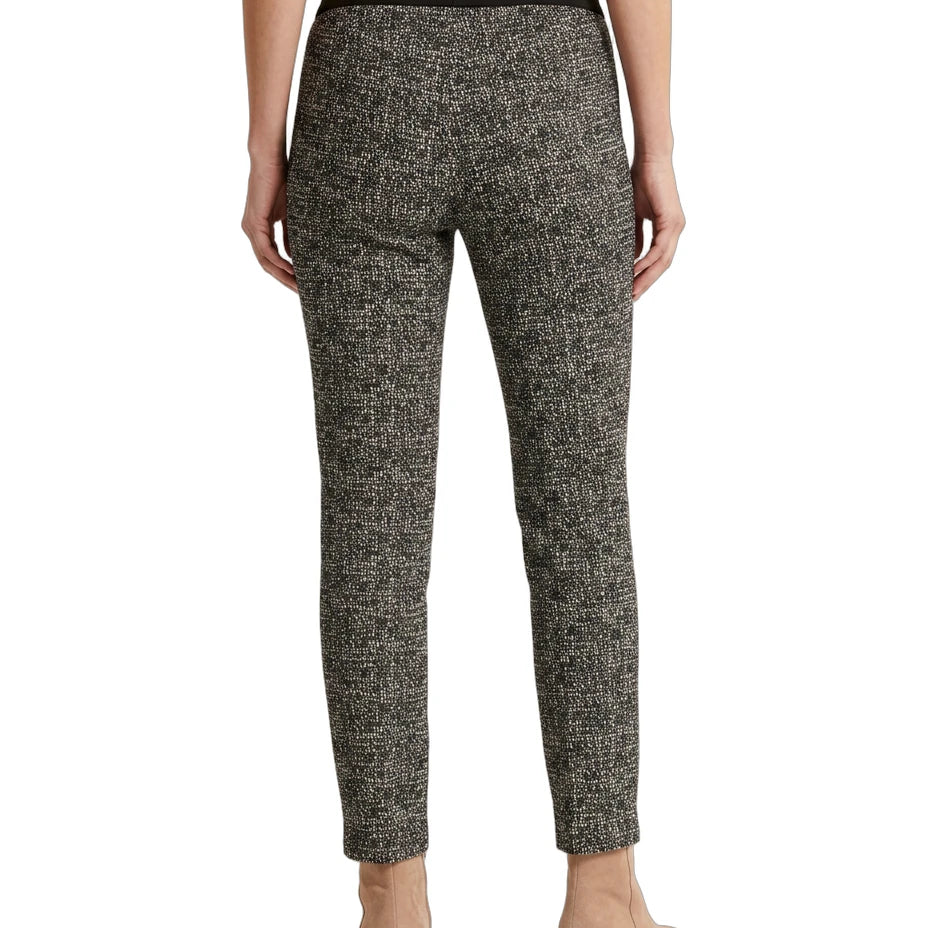 Person wearing black and white patterned Calin Klein pants on a white background