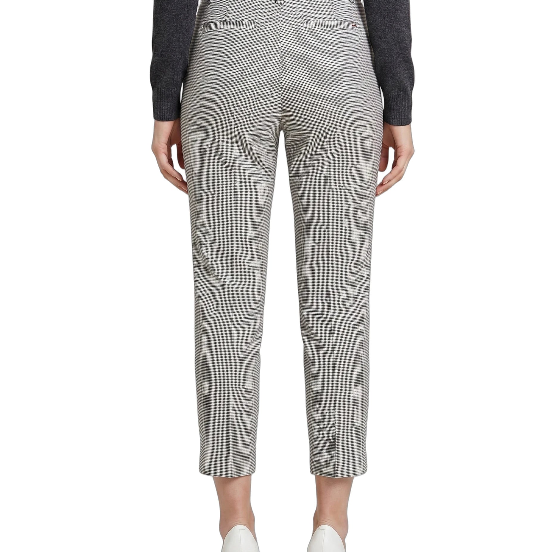 Light gray Calin Klein pants worn by a person on a white background