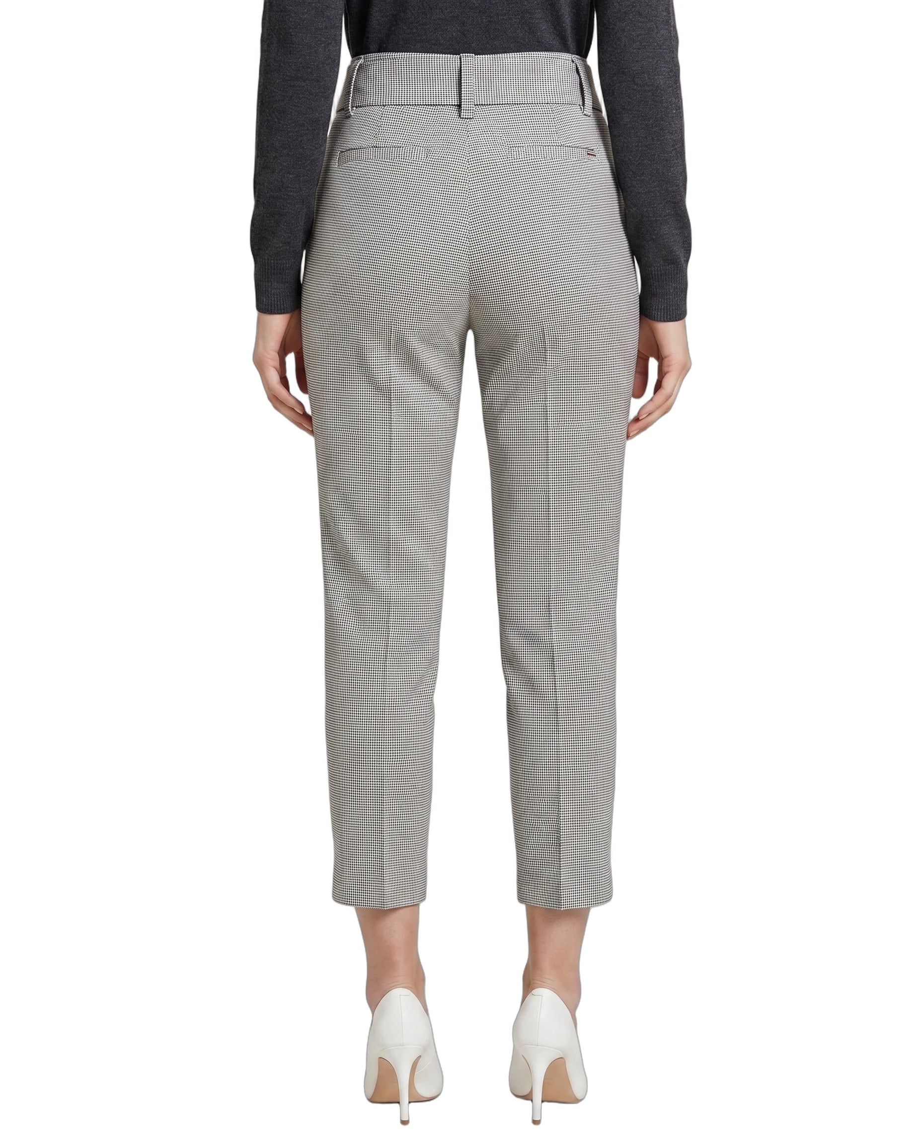 Light gray Calin Klein pants worn by a person on a white background