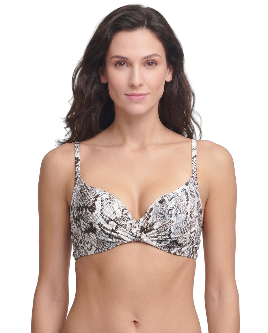 Woman wearing a patterned Calin Klein bikini top on a white background