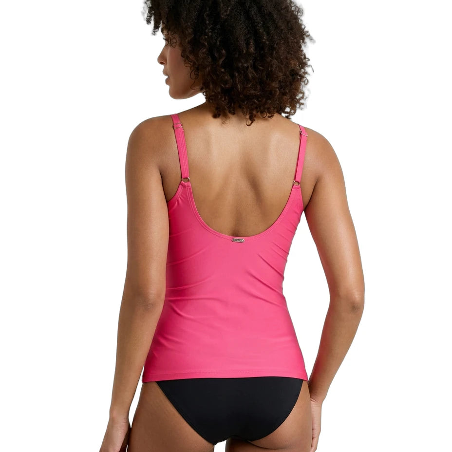 Woman wearing a pink Calvin Klein swimsuit with black bottoms on a white background