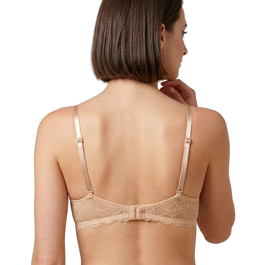 Woman wearing a beige Calvin Klein bra on a white background