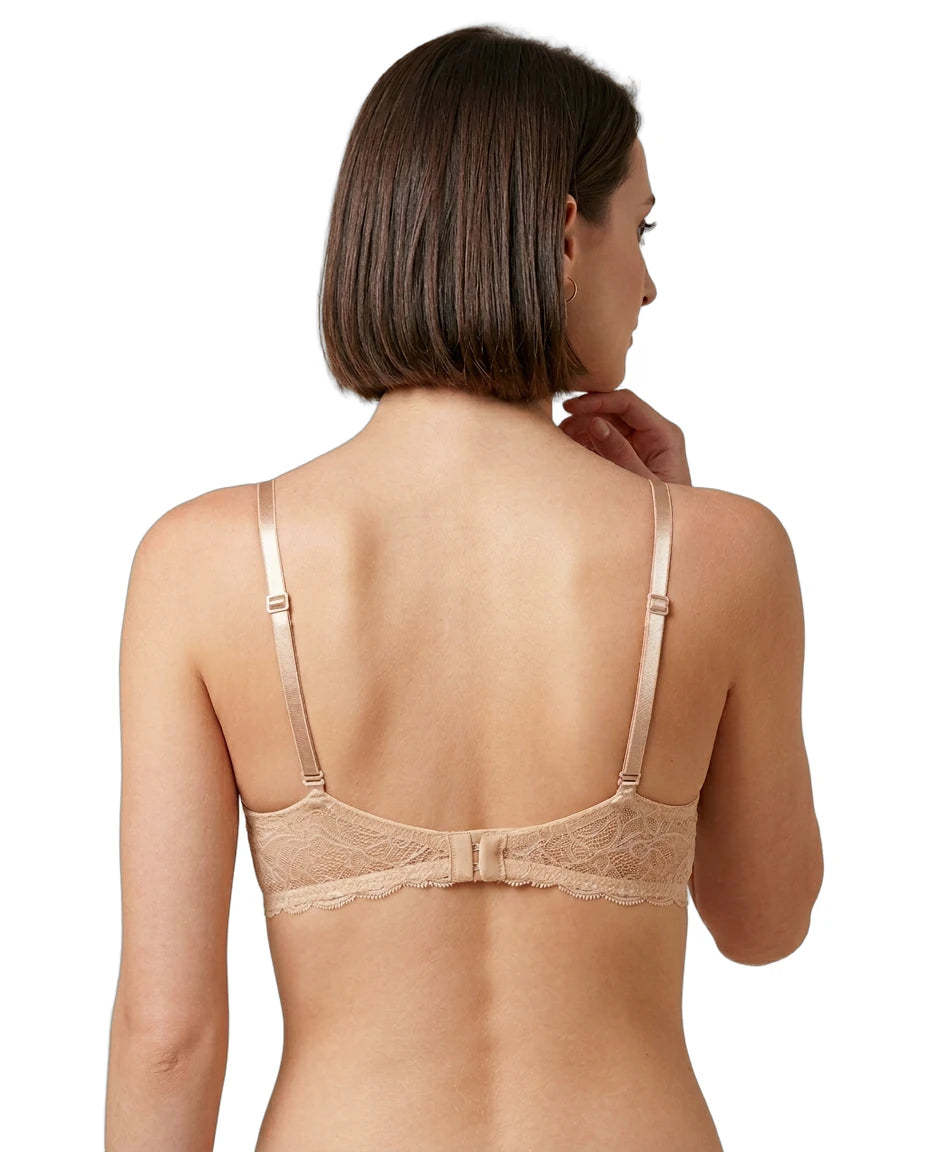 Woman wearing a beige Calvin Klein bra on a white background