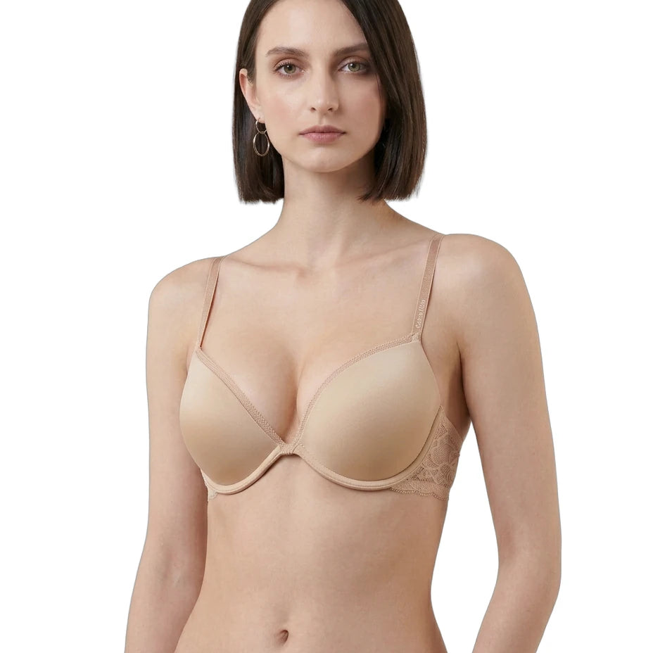 Woman wearing a beige Calvin Klein bra on a white background