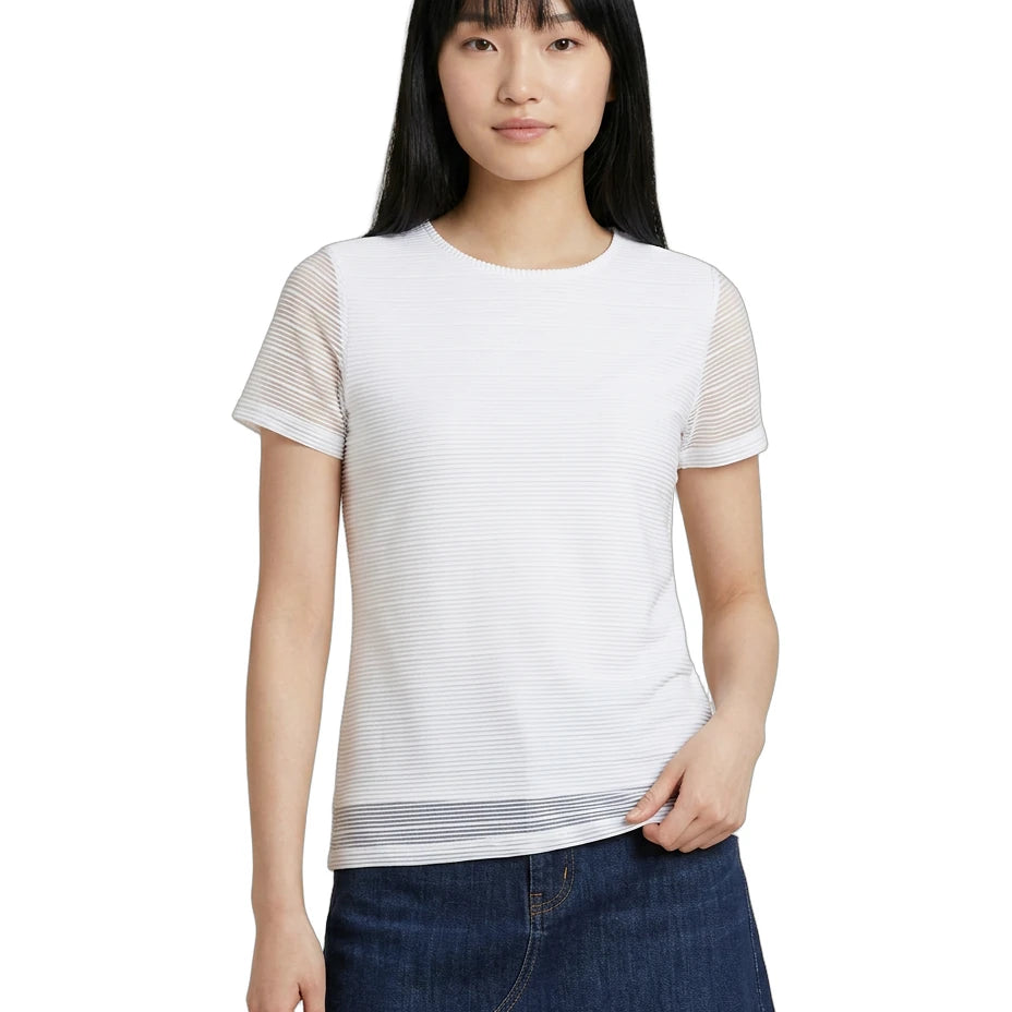 Woman wearing a white Calvin Klein t-shirt with sheer sleeves on a white background