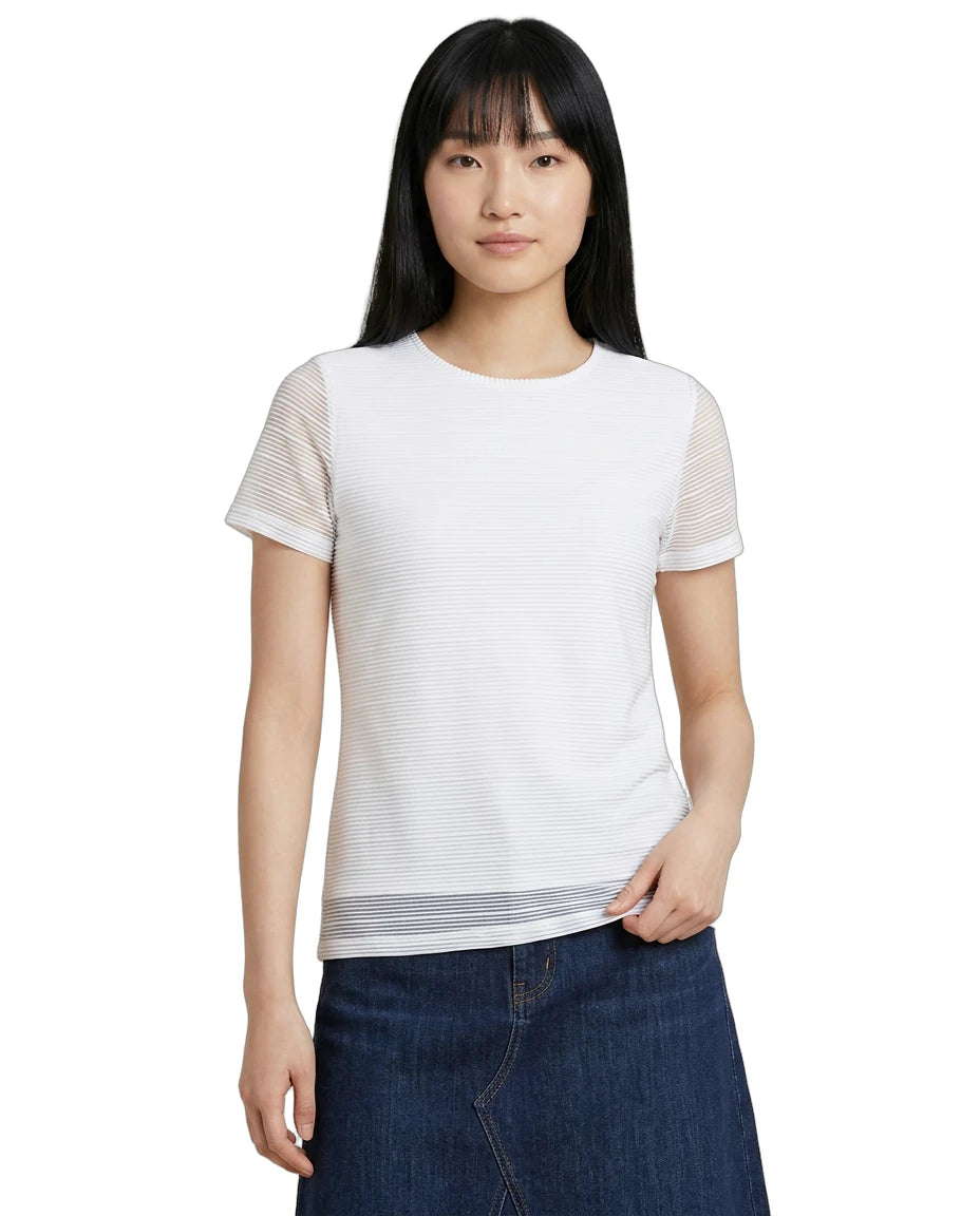 Woman wearing a white Calvin Klein t-shirt with sheer sleeves on a white background