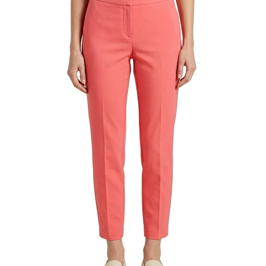 Person wearing coral Calvin Klein pants on a white background