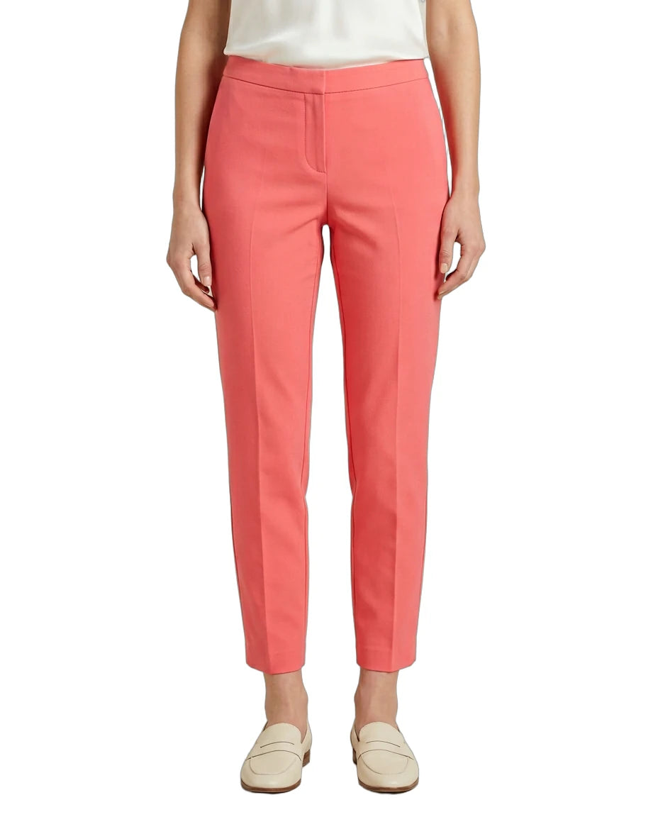 Person wearing coral Calvin Klein pants on a white background