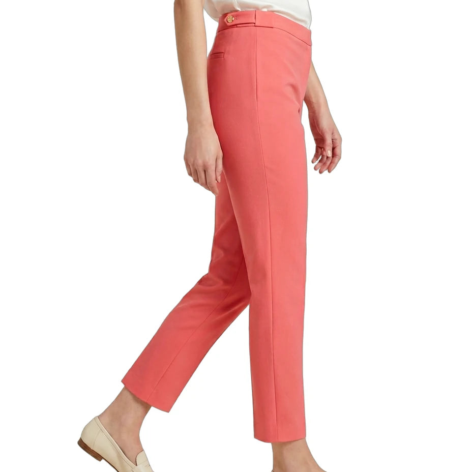 Person wearing Calvin Klein coral pants and white top on a white background