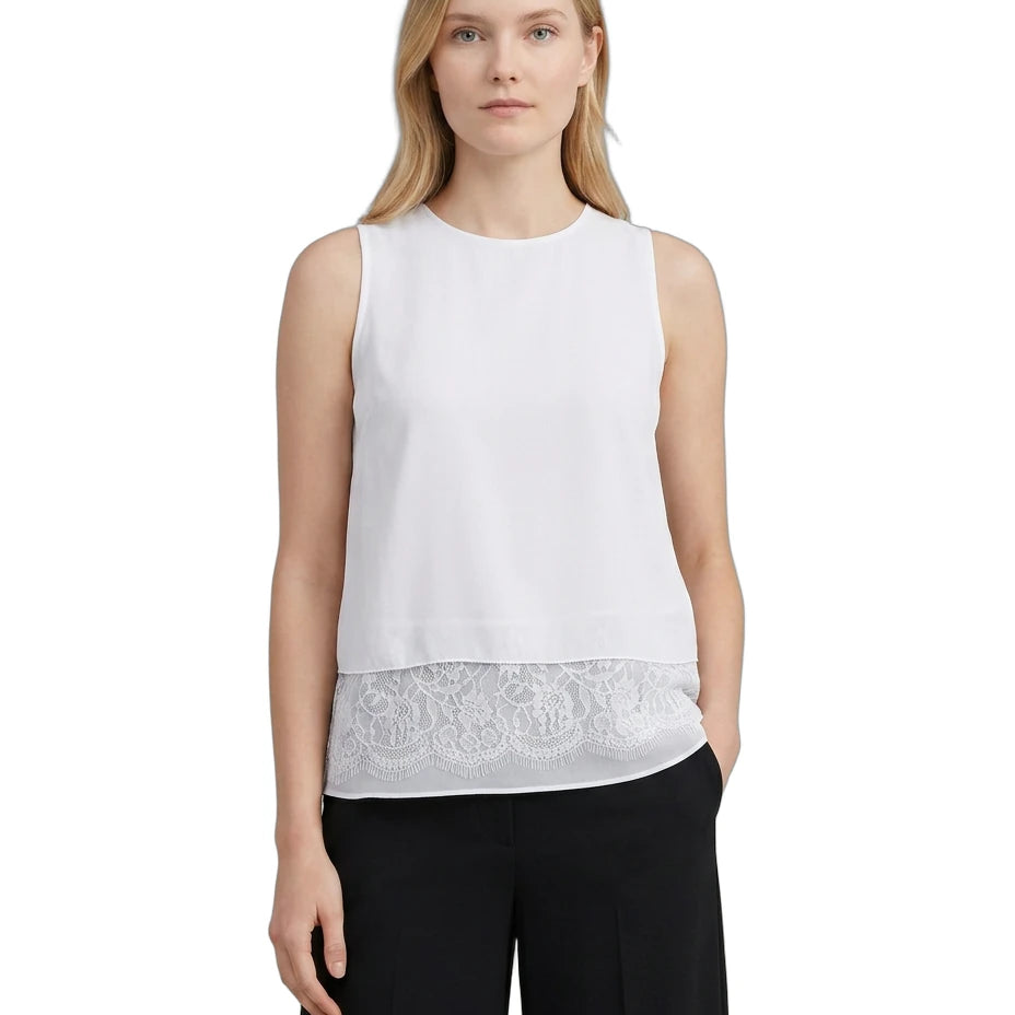 Woman wearing a white sleeveless Calvin Klein top with lace trim on a white background