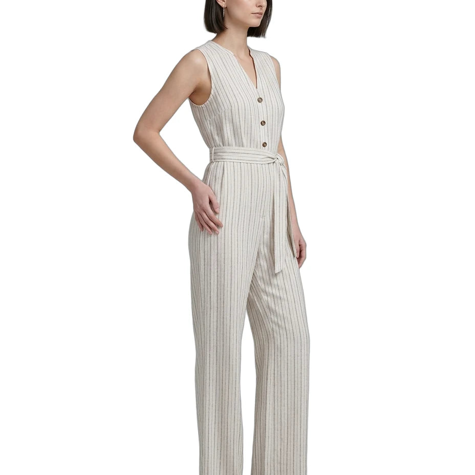 Woman wearing a sleeveless striped Calvin Klein jumpsuit on a white background