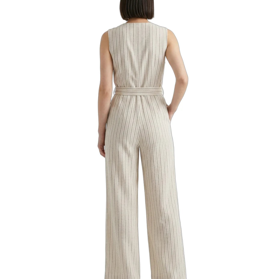 Woman wearing a striped Calvin Klein jumpsuit on a white background