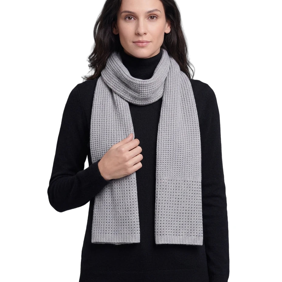 Woman wearing a gray Calvin Klein scarf on a white background