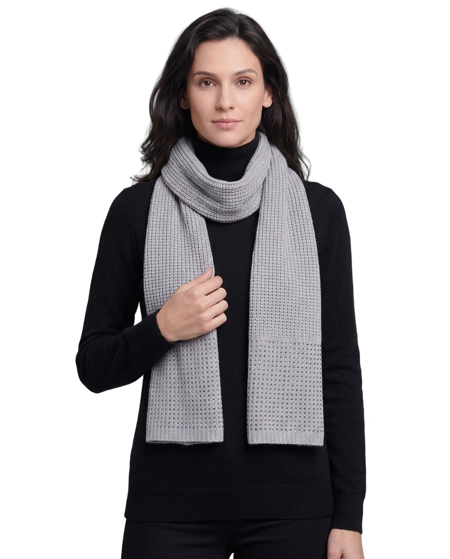 Woman wearing a gray Calvin Klein scarf on a white background