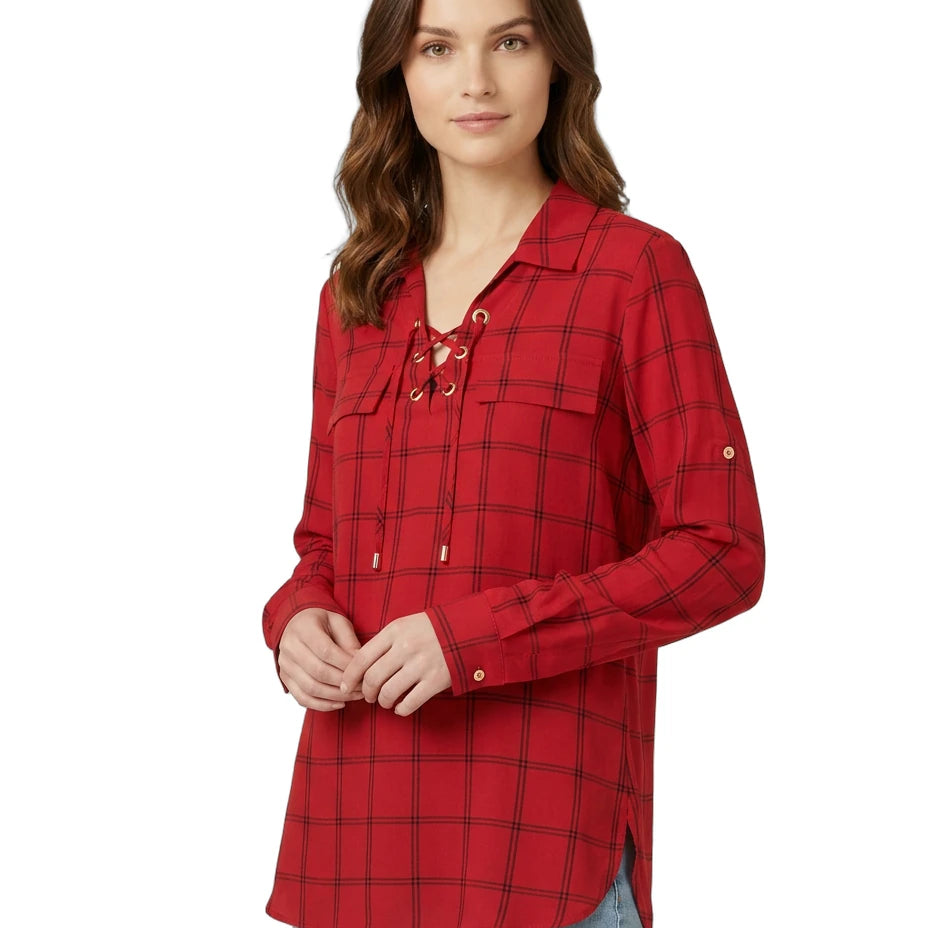 Woman wearing a red plaid Calvin Klein shirt on a white background