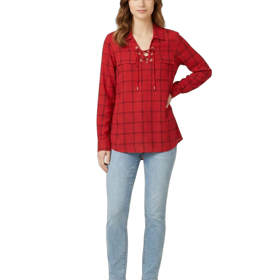 Woman wearing a red plaid Calvin Klein shirt and blue jeans on a white background