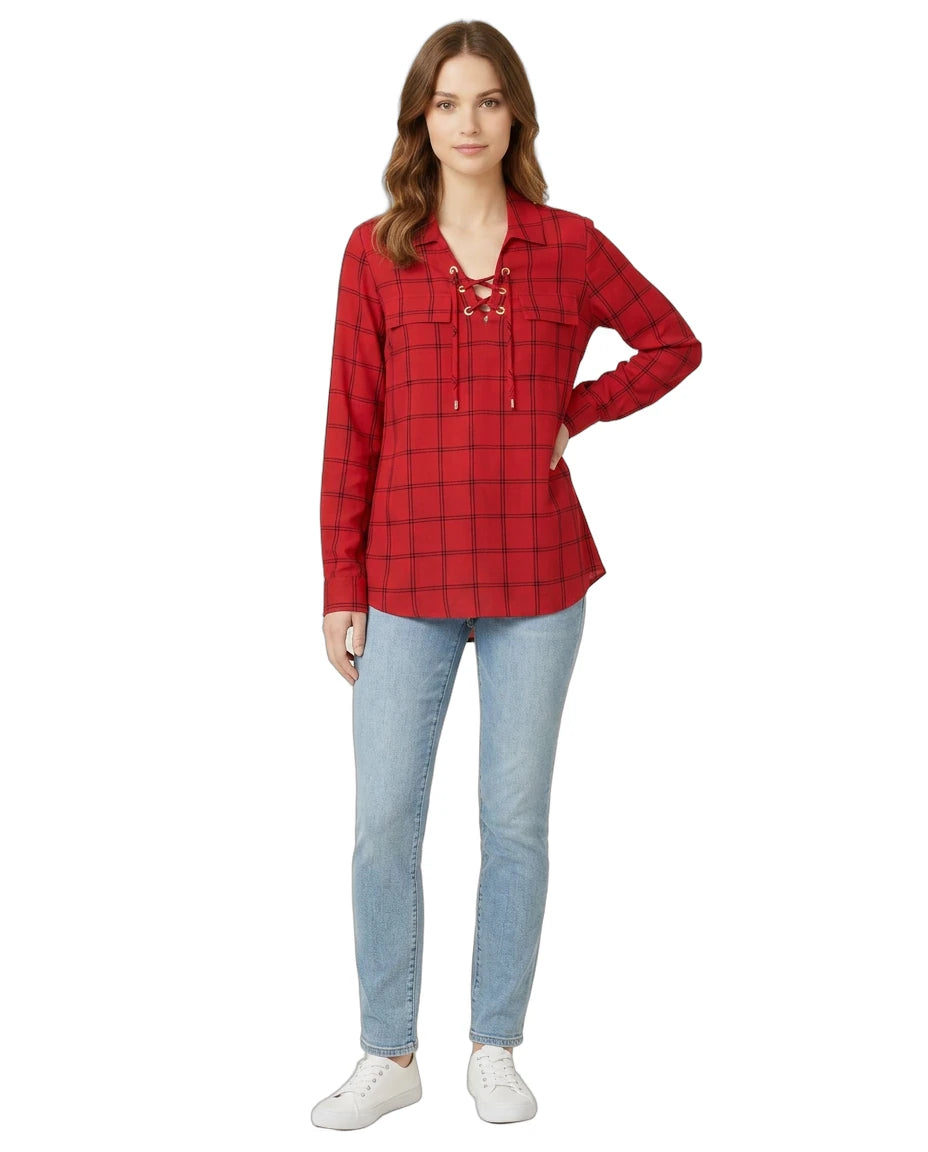 Woman wearing a red plaid Calvin Klein shirt and blue jeans on a white background