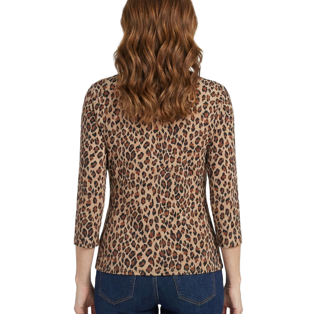 Woman wearing a leopard print top with a plain background