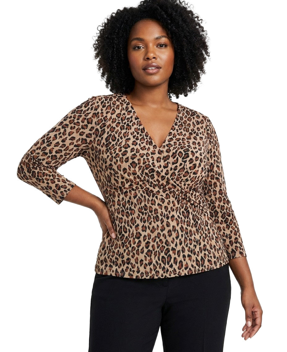 Woman wearing a leopard print top on a white background