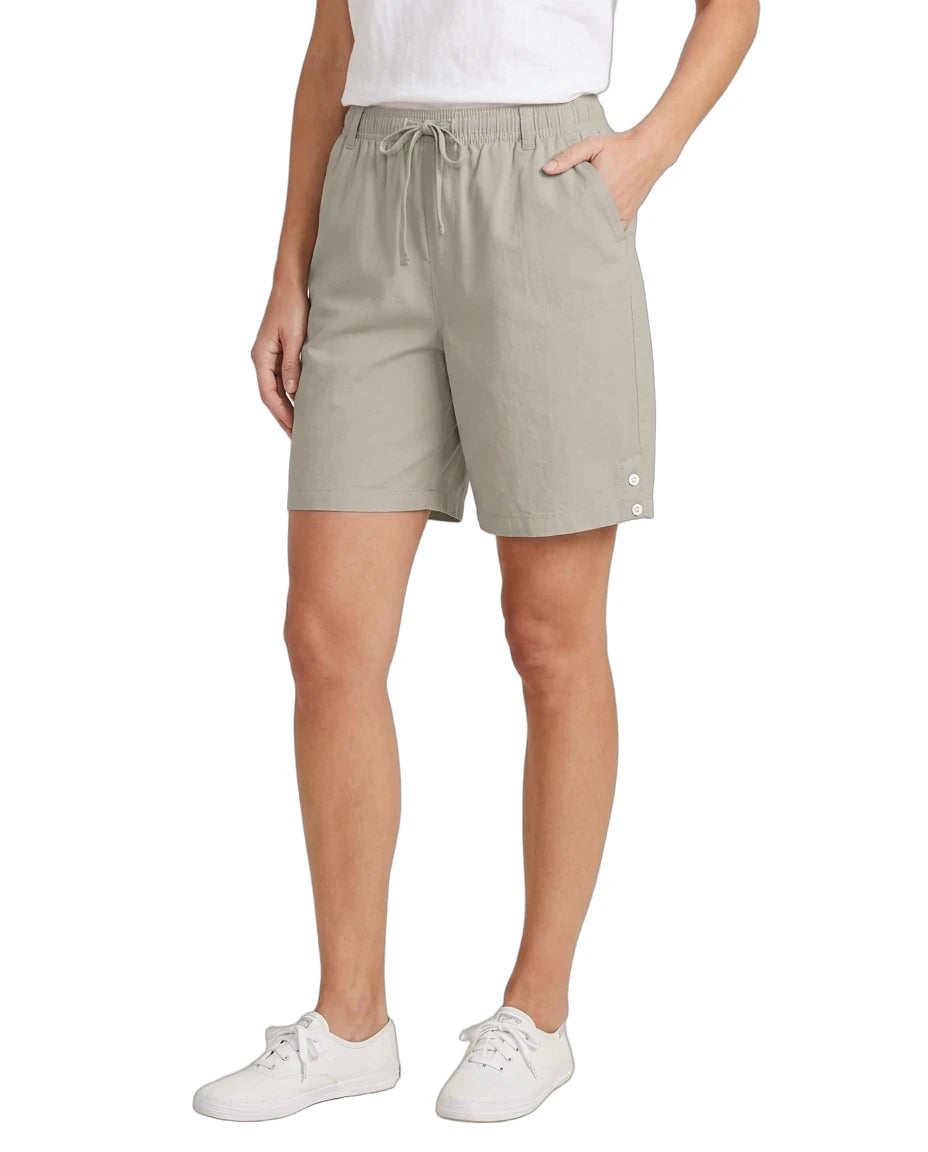 Person wearing beige shorts on a white background