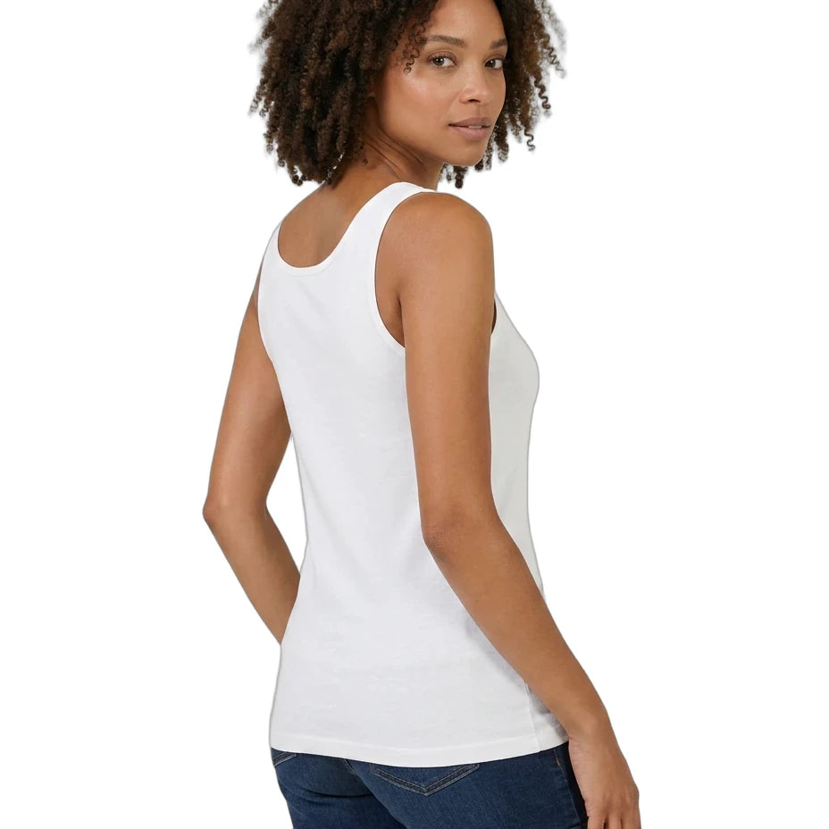 Woman wearing a white tank top and denim shorts on a white background