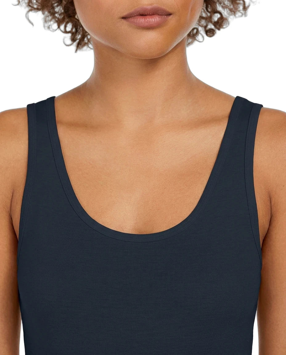 Person wearing a black tank top on a white background